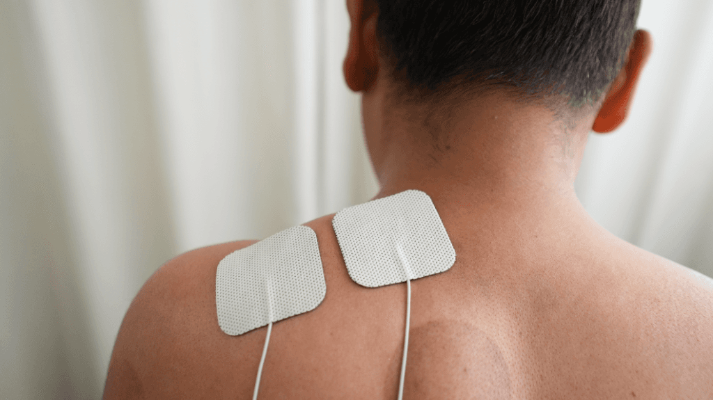 Transcutaneous Electrical Nerve Stimulation (TENS) electrotherapy session for upper back and shoulder pain relief at Zen Physiotherapy Clinic Nashik